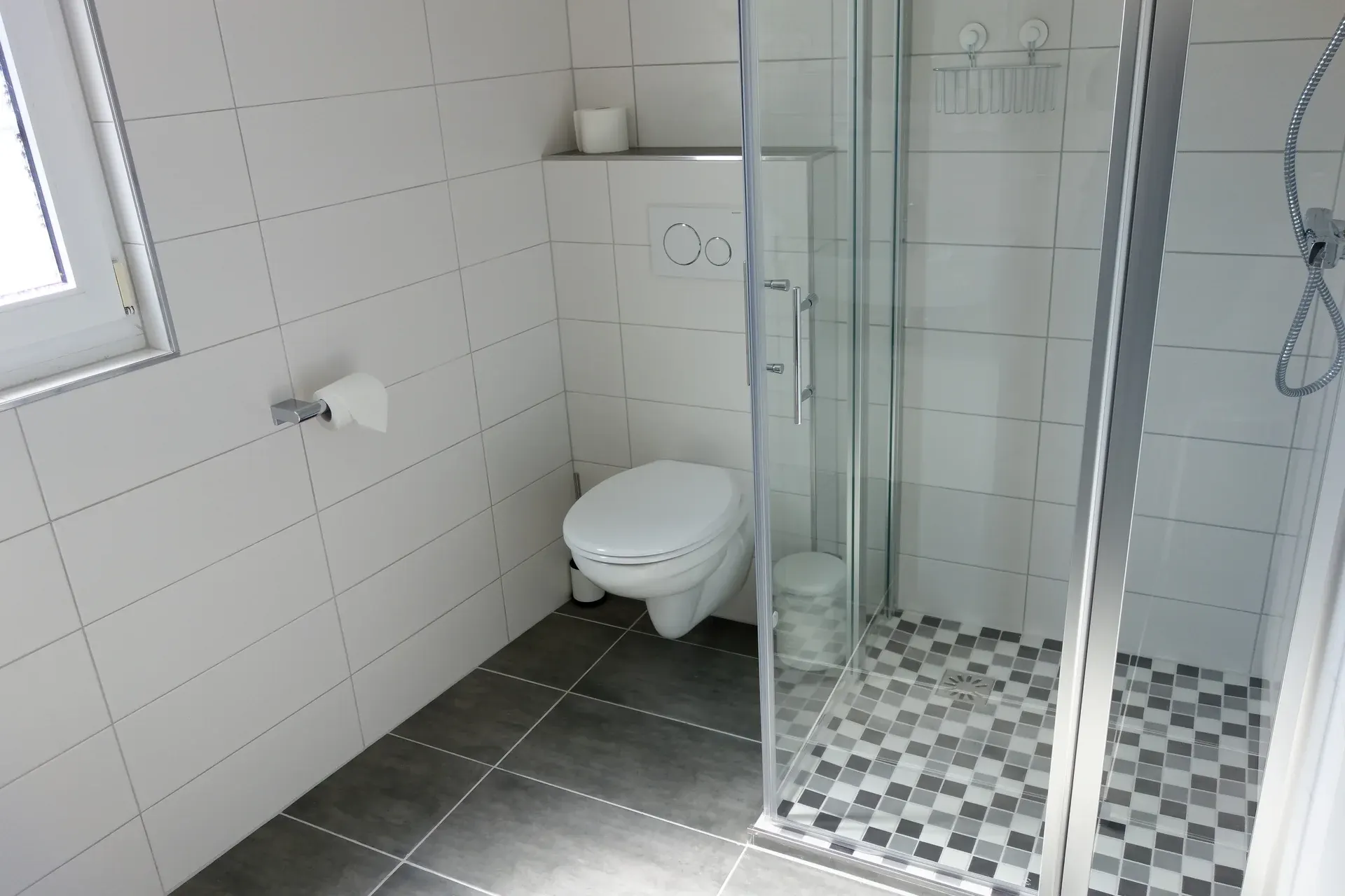 Bathroom in the family accommodation, with shower and washbasin