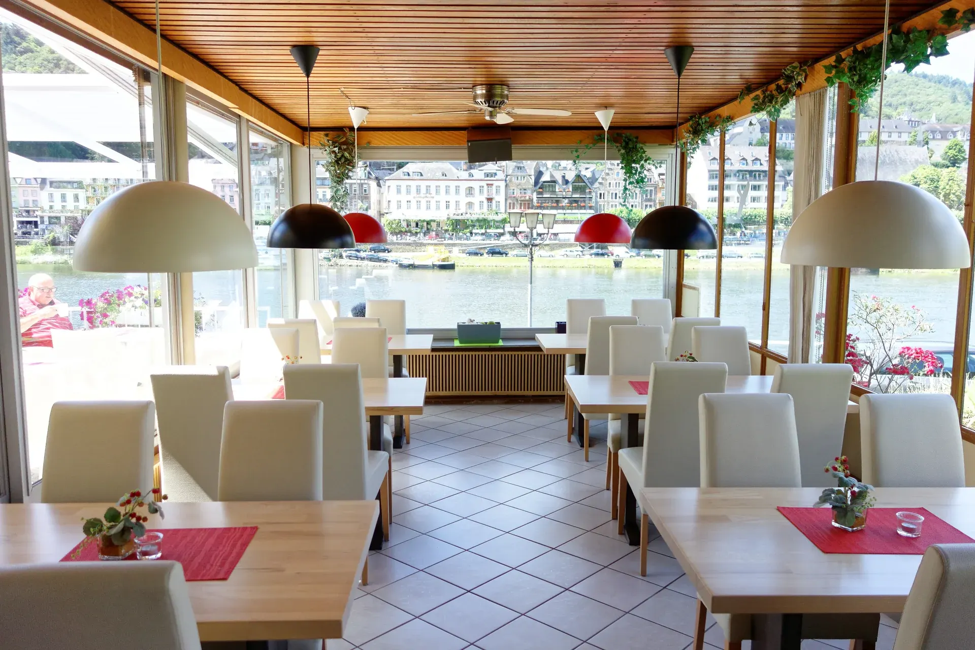 Restaurant with tables set for dining and wide windows